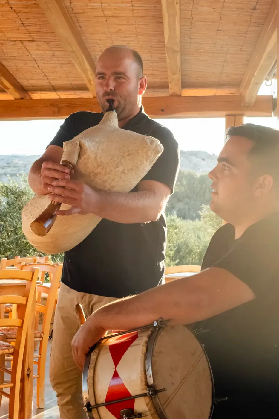 Gerasimos Sykiniotis playing the traditional tsampouna during the tour in Mykonian Land